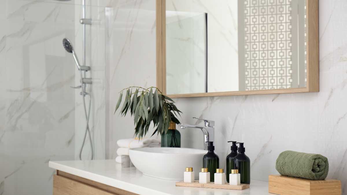 Modern bathroom interior with white marble tiles a circular basin, and minimalist decor