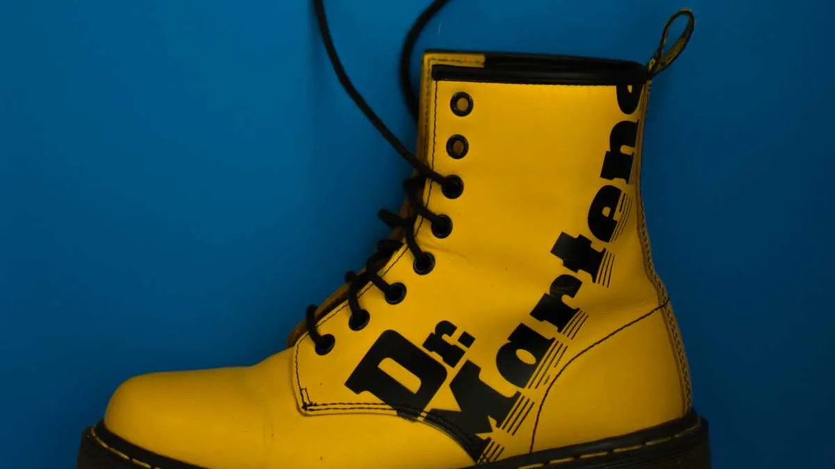 Iconic yellow Dr Martens boot on a blue background