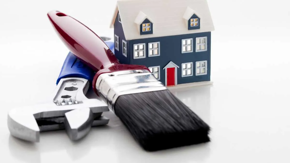 Home improvement tools with a model house, signifying DIY or renovation projects