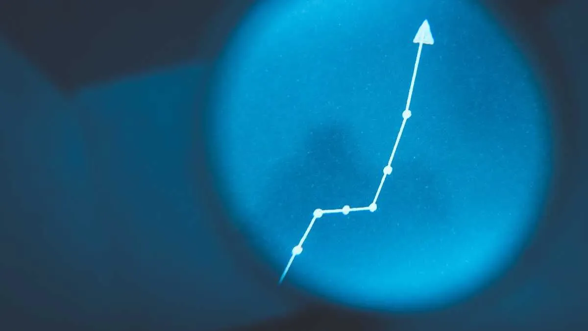 A blurred upward trend graph on a blue background