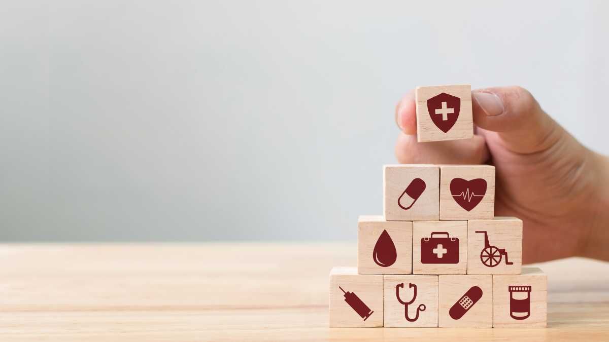 Wooden blocks stacked with health related icons symbolising healthcare management or medical data