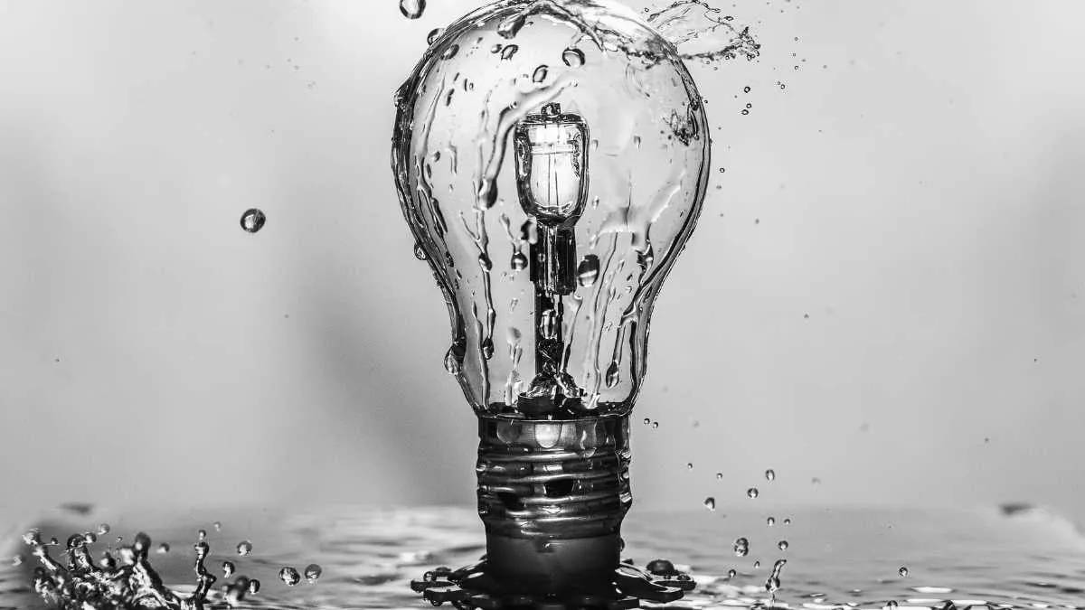 Light Bulb surrounded by splashing water droplets.