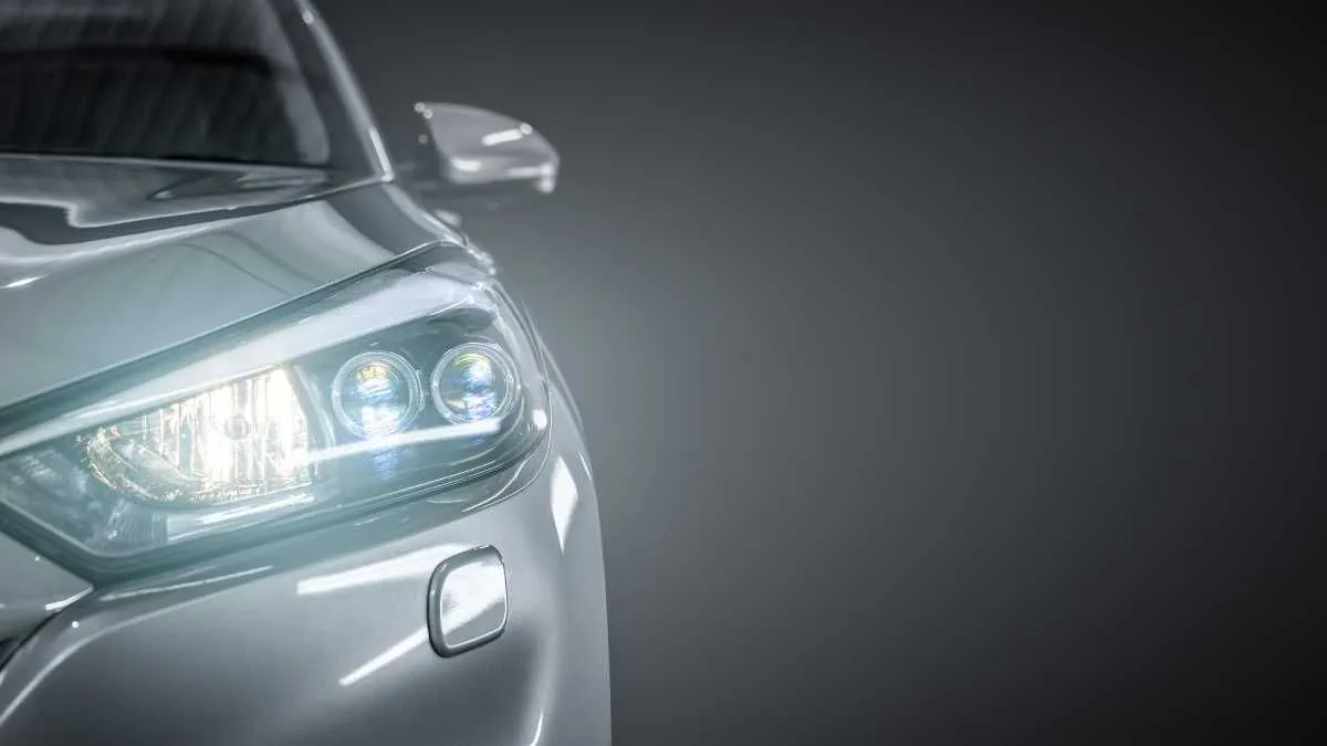 Close up of a cars headlight and partial front grill showcasing modern vehicle design