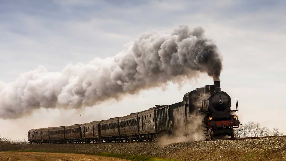 Vintage steam train moving through the countryside