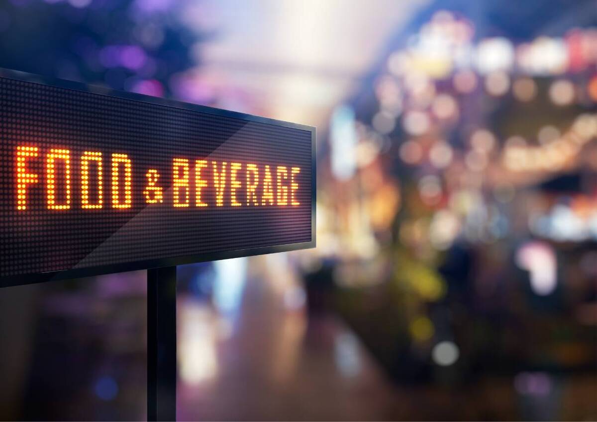 Digital sign saying FOOD and BEVERAGE likely in a shopping or dining area