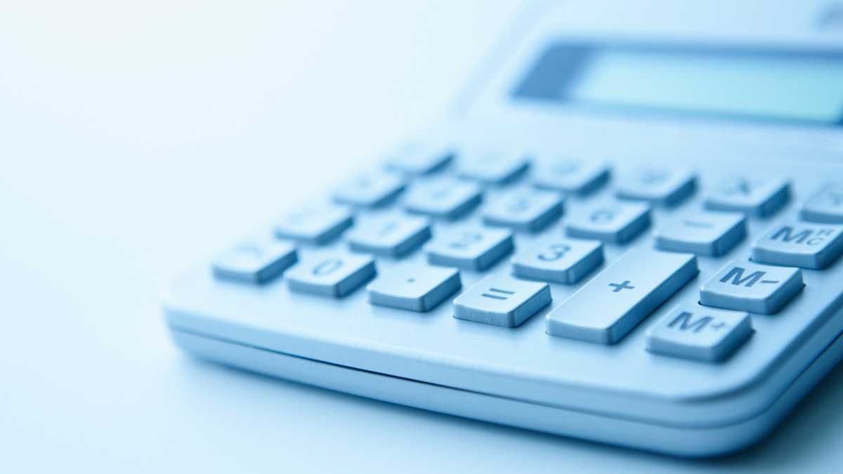 Close up of a calculator on a blue background