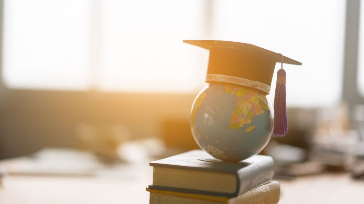 a small globe with a graduation cap on top of it suggesting a theme of global education or achievement