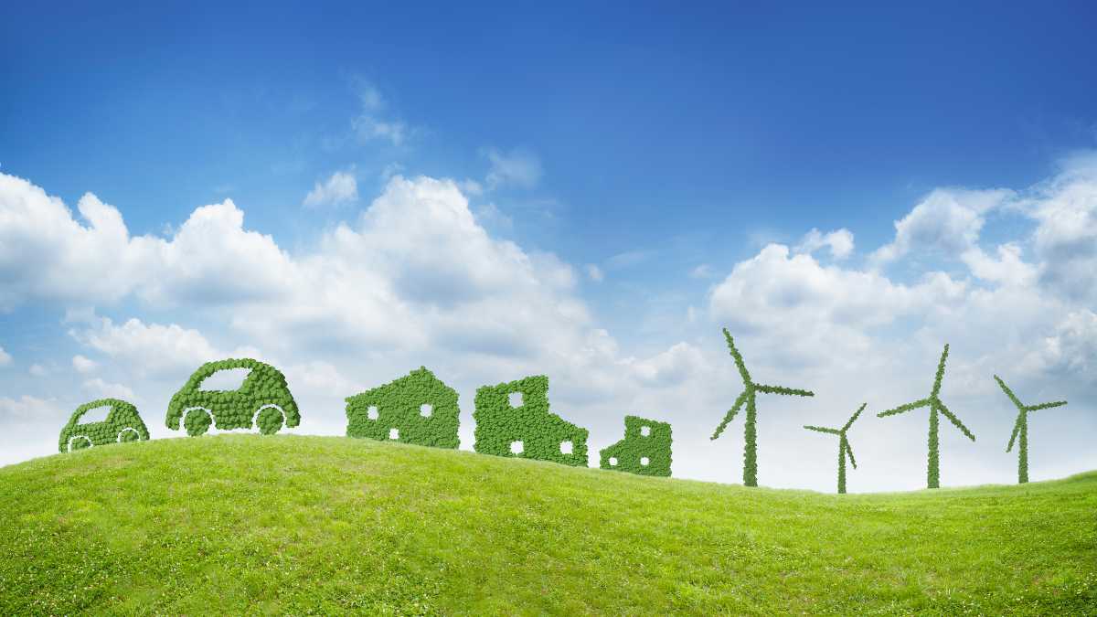 Green energy concept with leafy cars houses and wind turbines