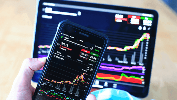 Trading chart on phone and laptop