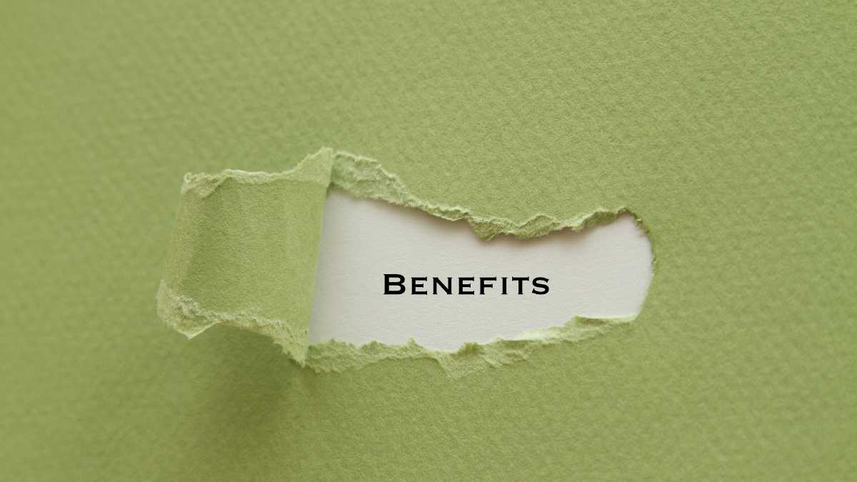 Torn green paper revealing the word BENEFITS underneath