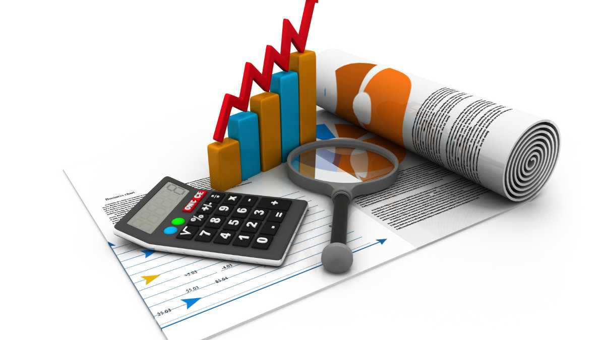 Financial analysis concept with a magnifying glass calculator charts and a printed report