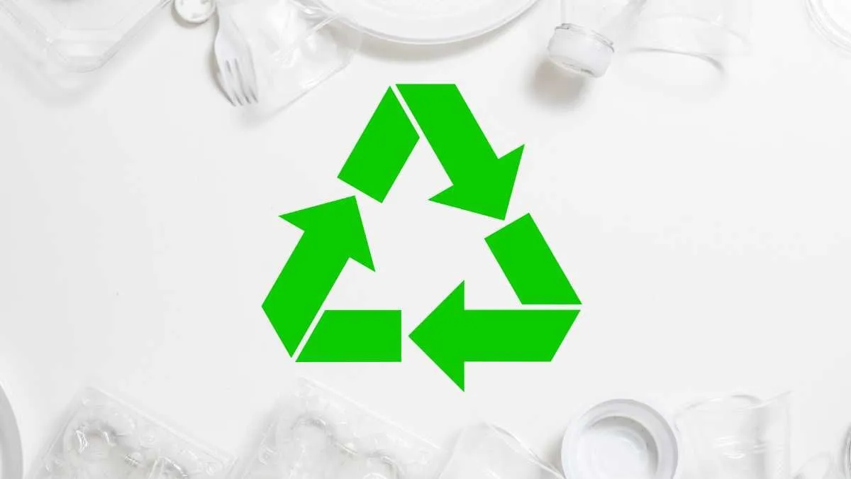 A symbol of recycling is superimposed on a background of disposable plastic items.