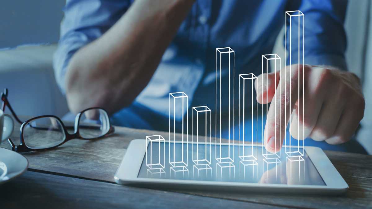 Image shows digital bars on a tablet, indicating financial analysis or data