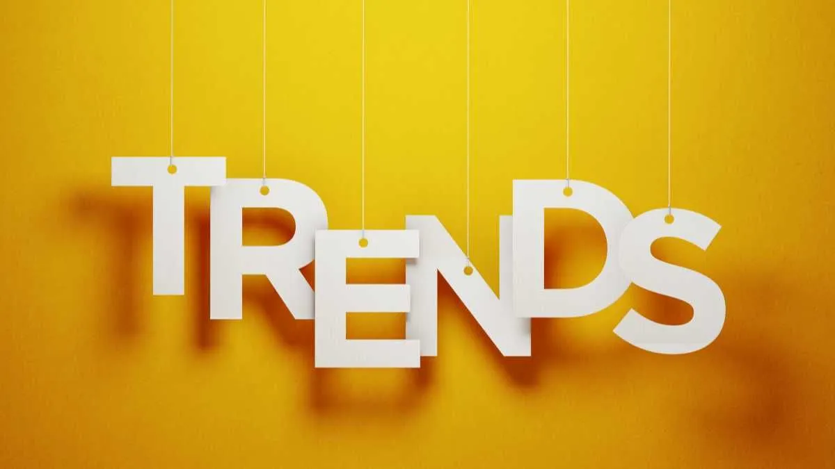 The word TRENDS in white 3D letters hanging against a yellow background