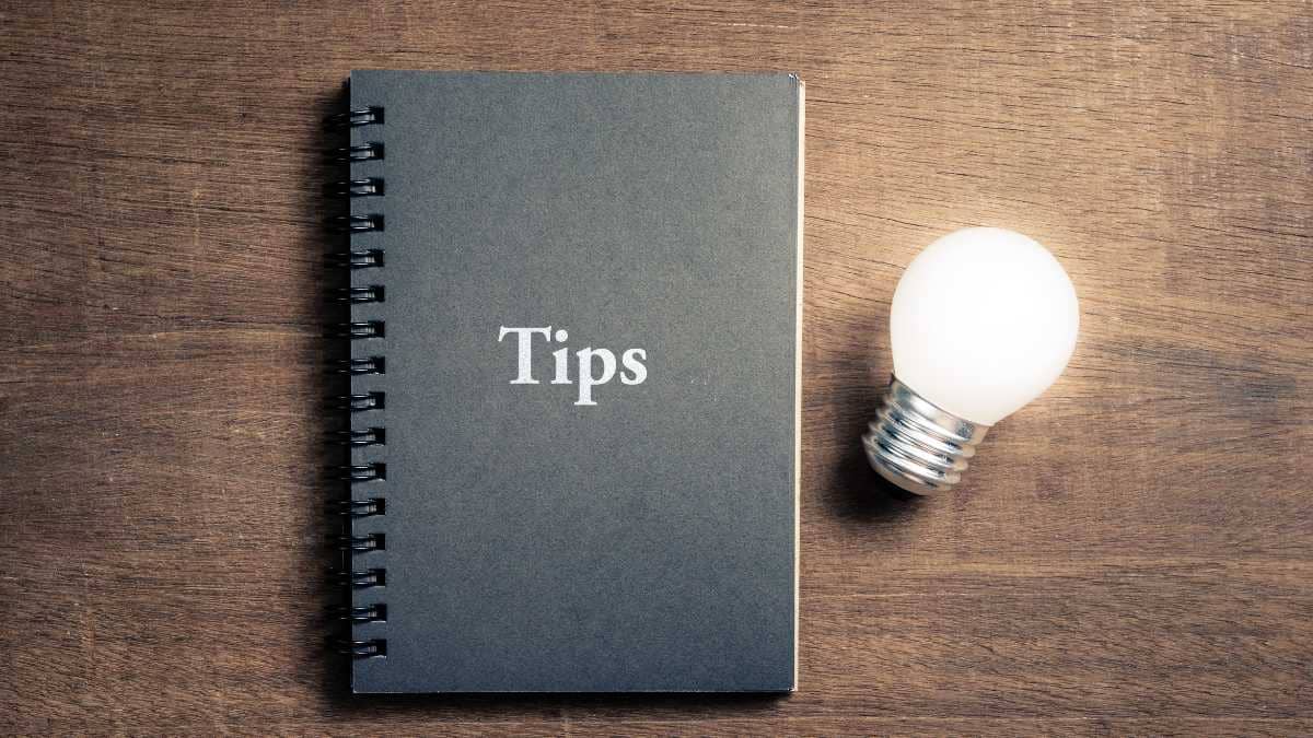 Notebook with Tips and a light bulb on a wooden table