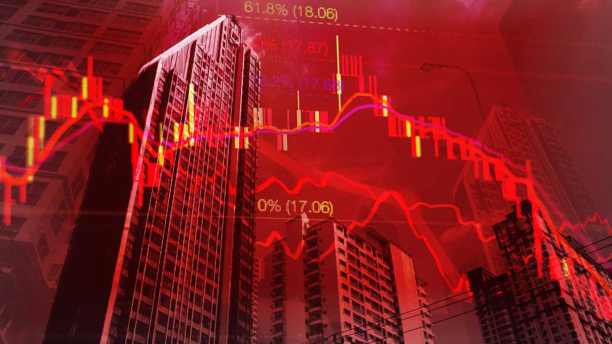 Red stock market graphs plunge amidst a dark cityscape