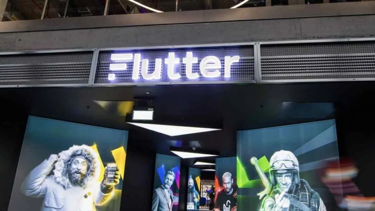 A building entrance crowned with a neon sign that reads FLUTTER