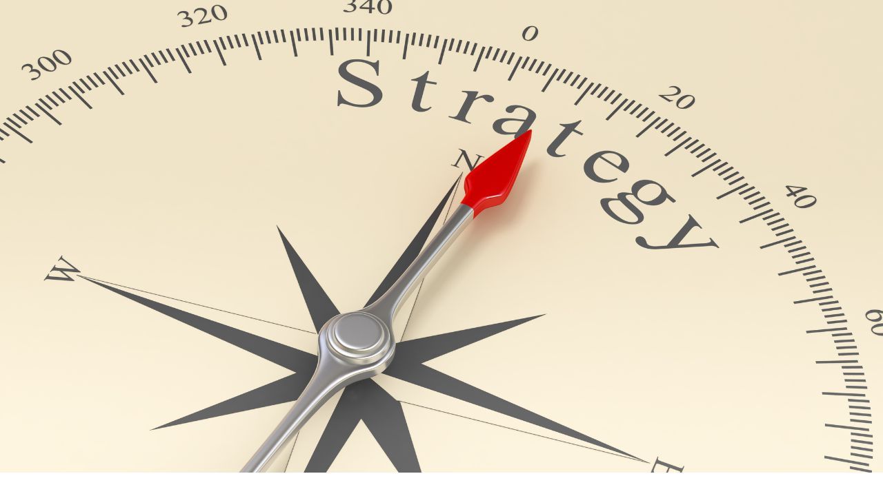 A compass with the needle pointing towards the word Strategy