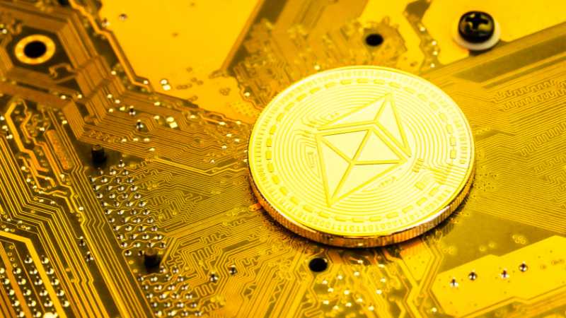 A gold Ethereum coin on a circuit board