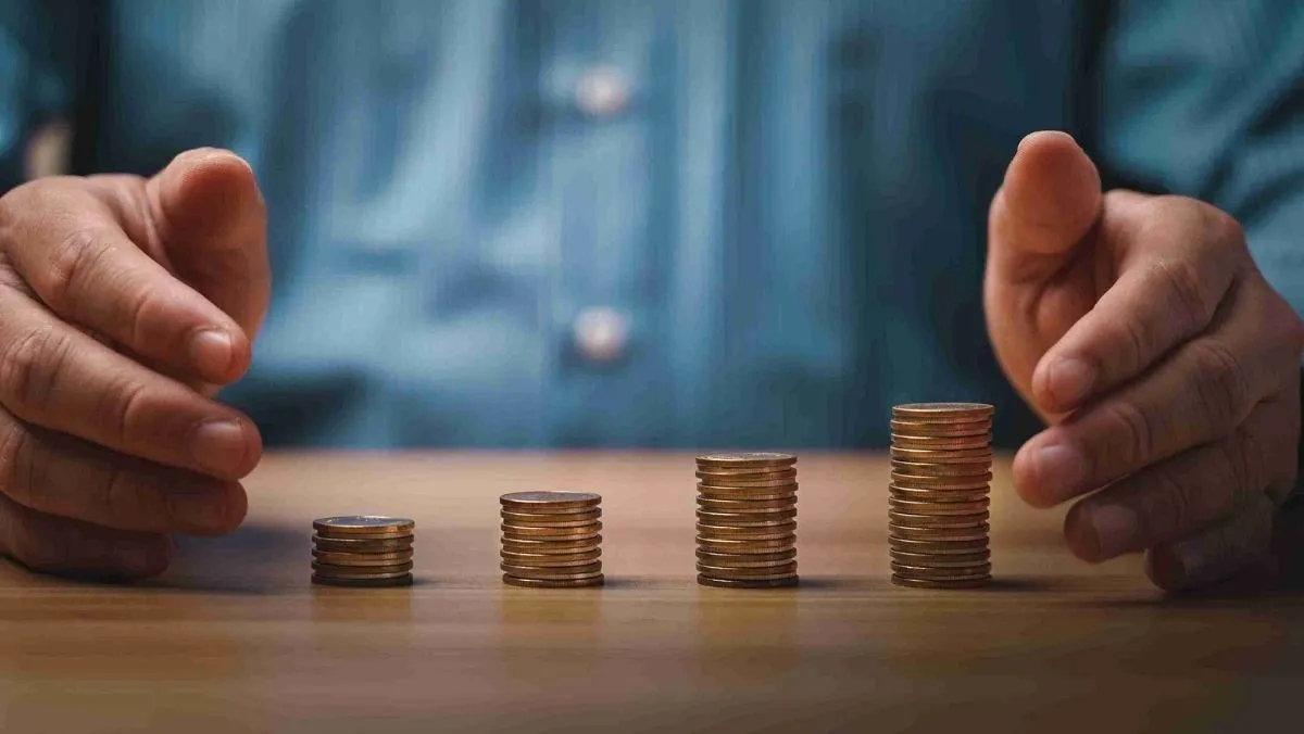 A man organizes and piles up coins