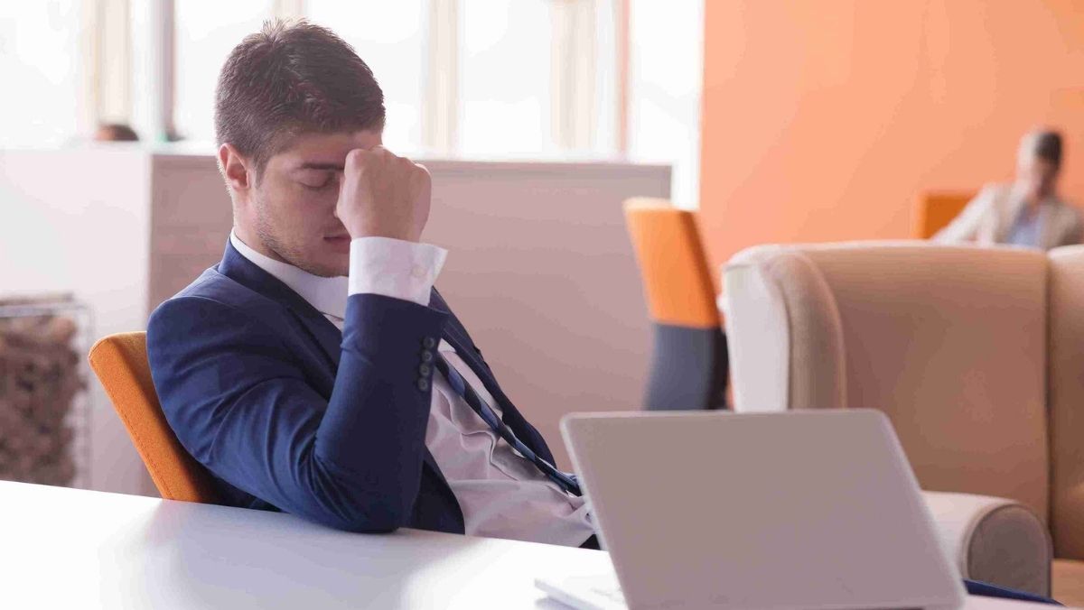 A man sits in his office, visibly frustrated