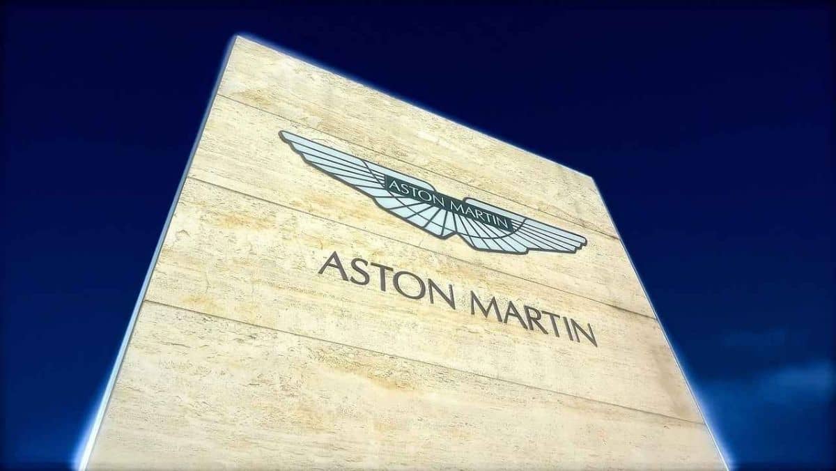 A towering wall featuring an embedded Aston Martin sign