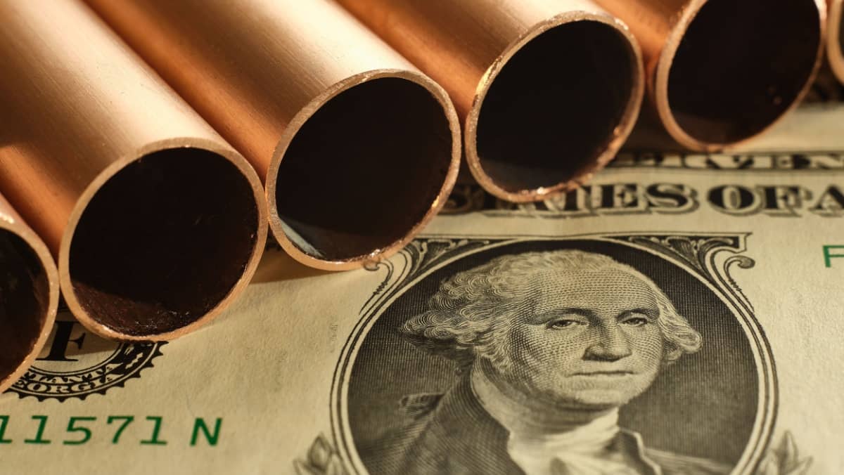  Close-up of copper pipes and United States dollar