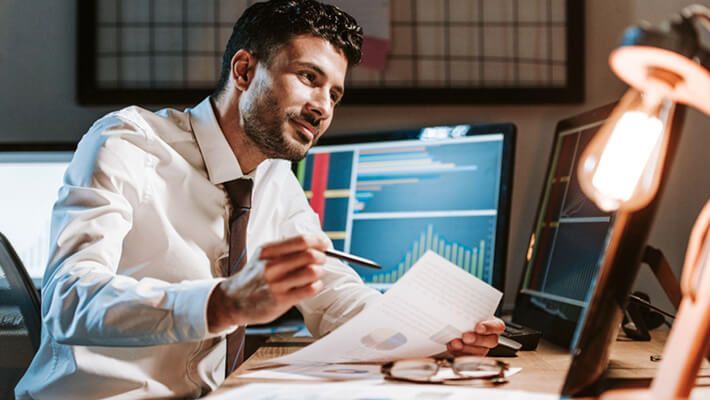 man studying a document for trading