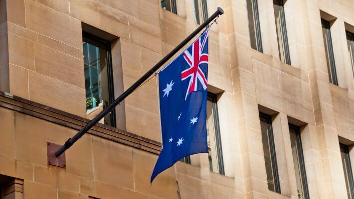 Flag of Australia hang from a sandstone building