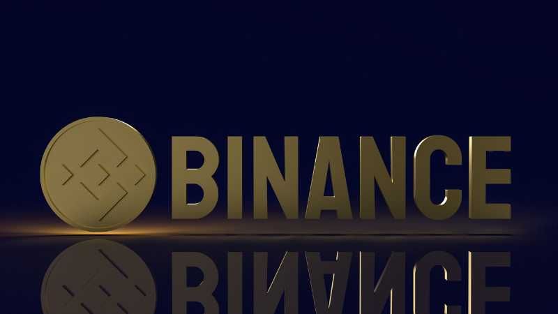 Gold Binance logo and coin on a dark background