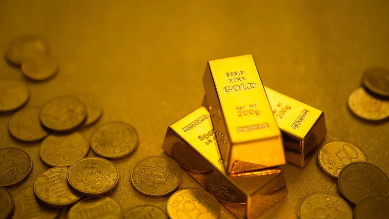 Gold bars and coins on a golden surface