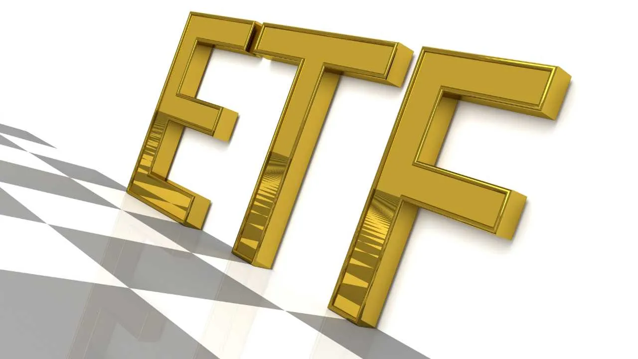 Golden 3D letters  ETF  with a shadow on white surface