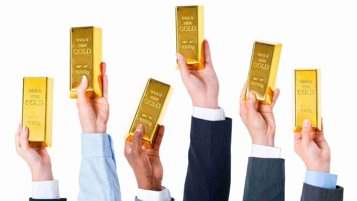 Hands lifting in a gesture of prosperity each holding a gold bar