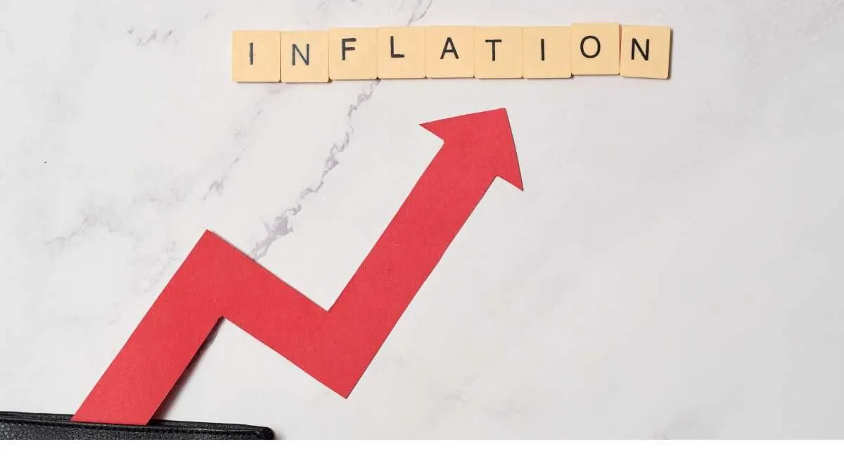 INFLATION in tiles above a rising arrow graph on marble