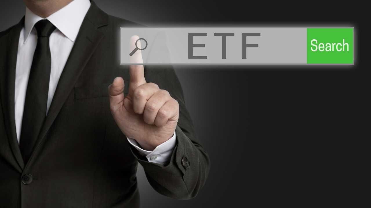 Man in a suit interacting with a virtual ETF search bar