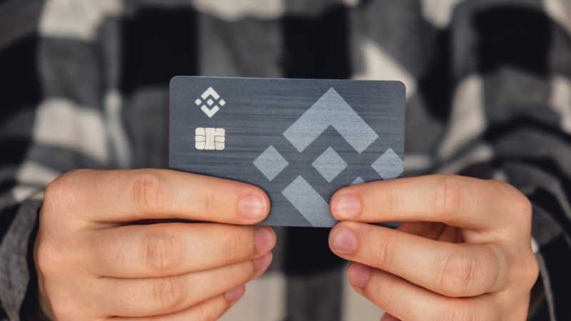 Person holding a card with geometric patterns and chip