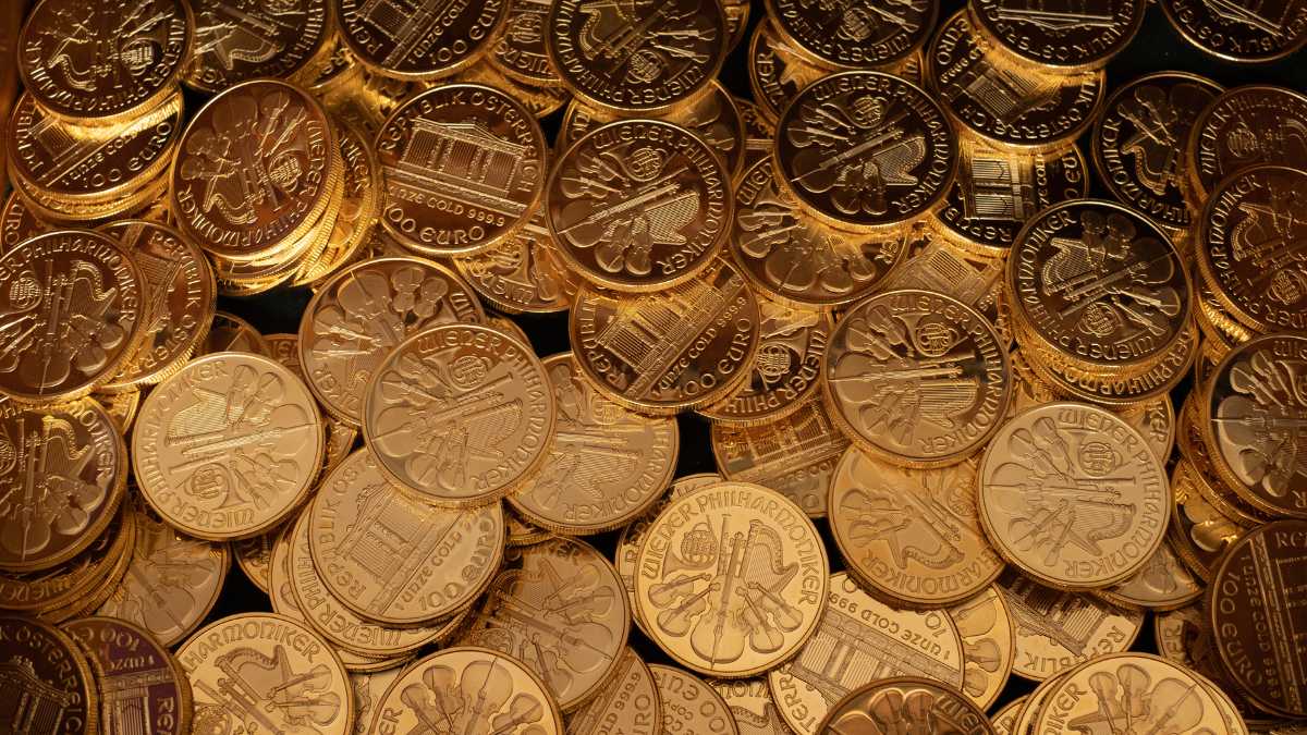 Pile of golden coins with various embossed designs