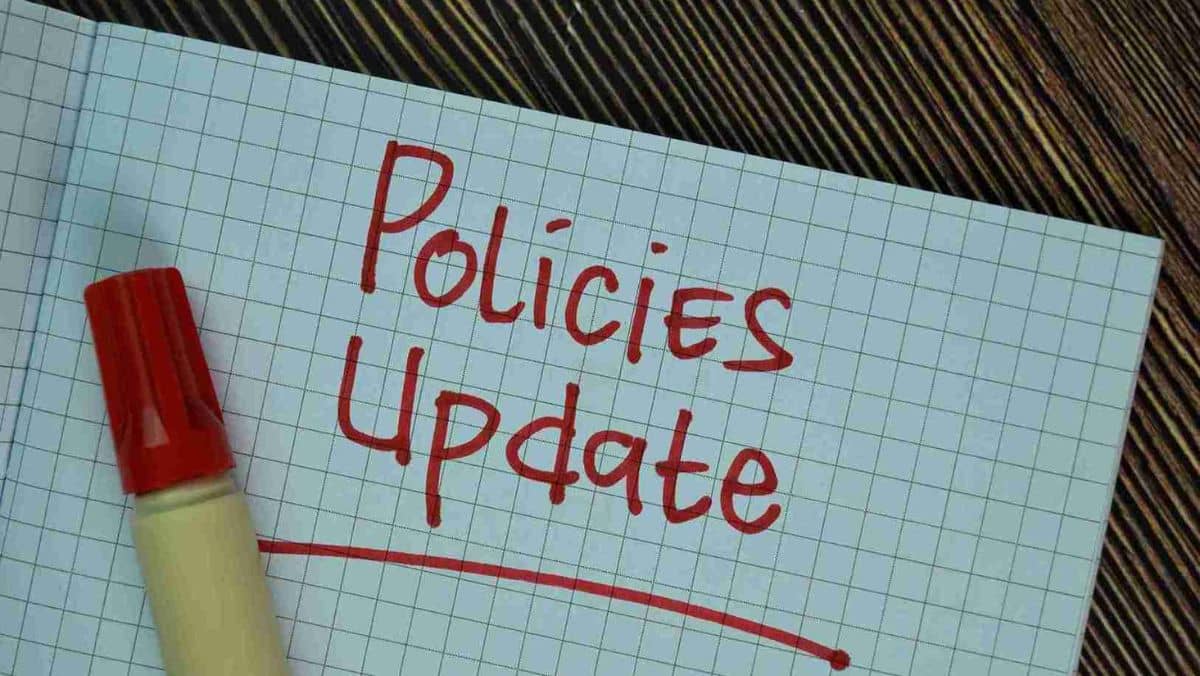 Policies Update written on a piece of paper beside a pen