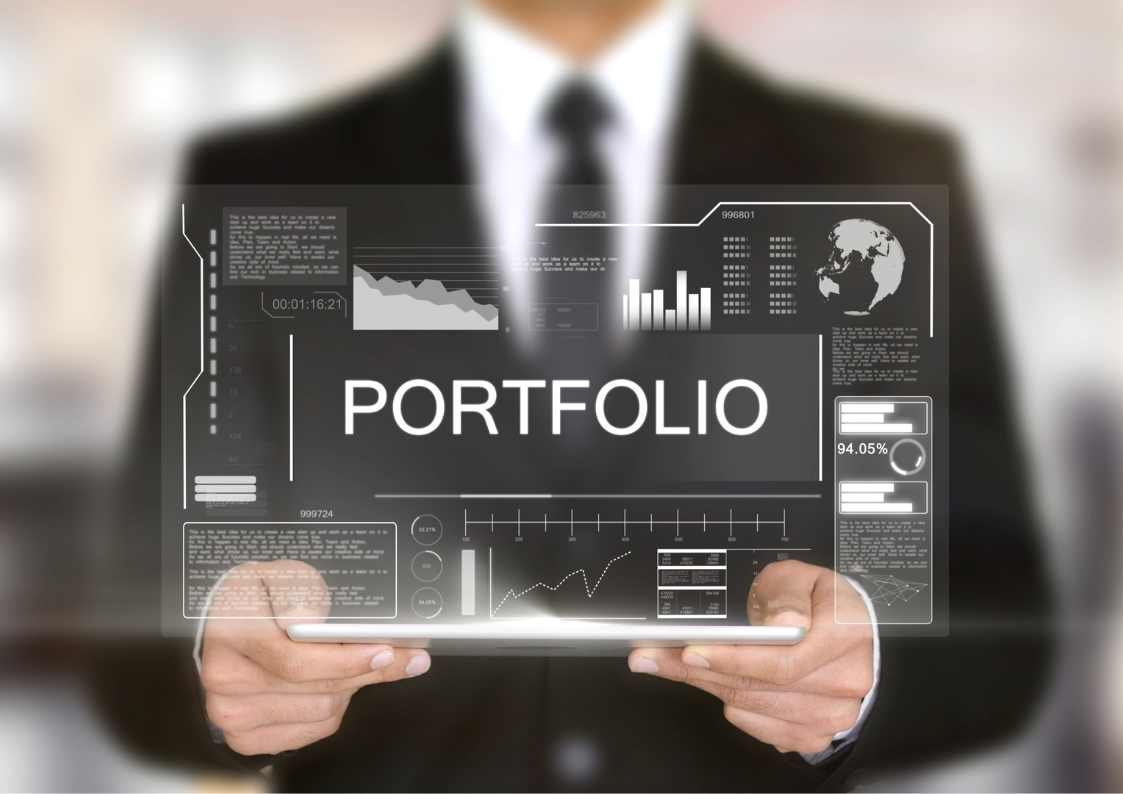 Person holding a transparent display showing the word PORTFOLIO with graphs and data