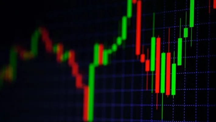 Blurry trading chart featuring red and green candlesticks with vibrant lines