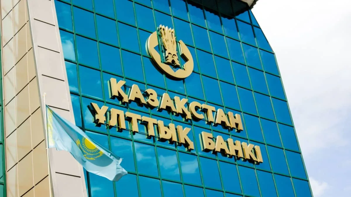 Kazakhstan National Bank with the national flag of the country on a cloudy summer day