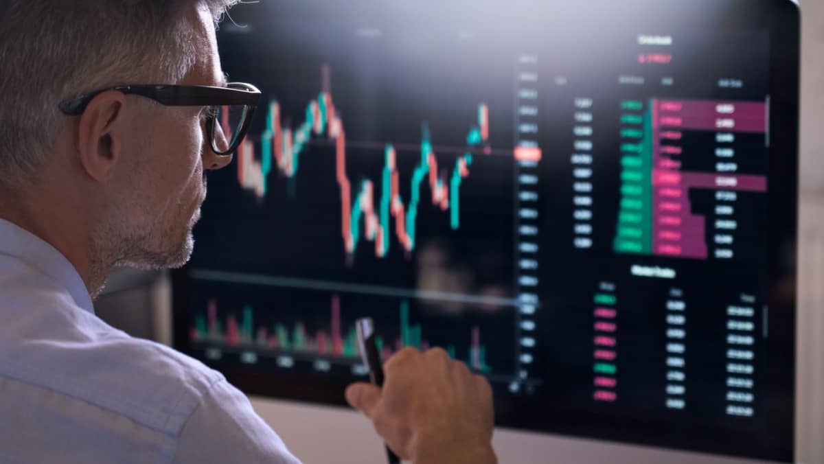 Trader engaged in market analysis, utilizing a computer to monitor the online commodity exchange