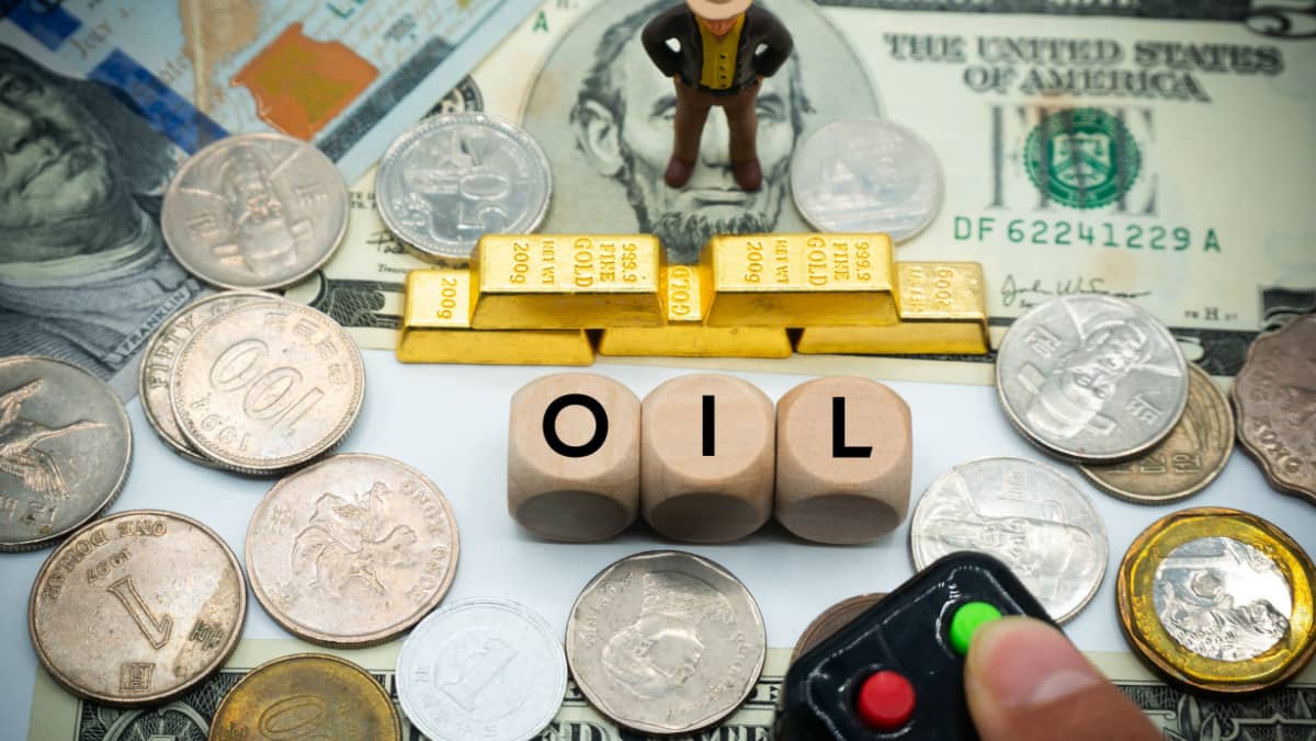 The word oil is written on the wooden dice on the money background