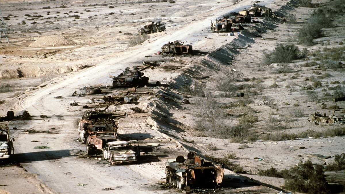 Iraqi armored personnel carriers tanks, and trucks destroyed in a coalition attack along a road