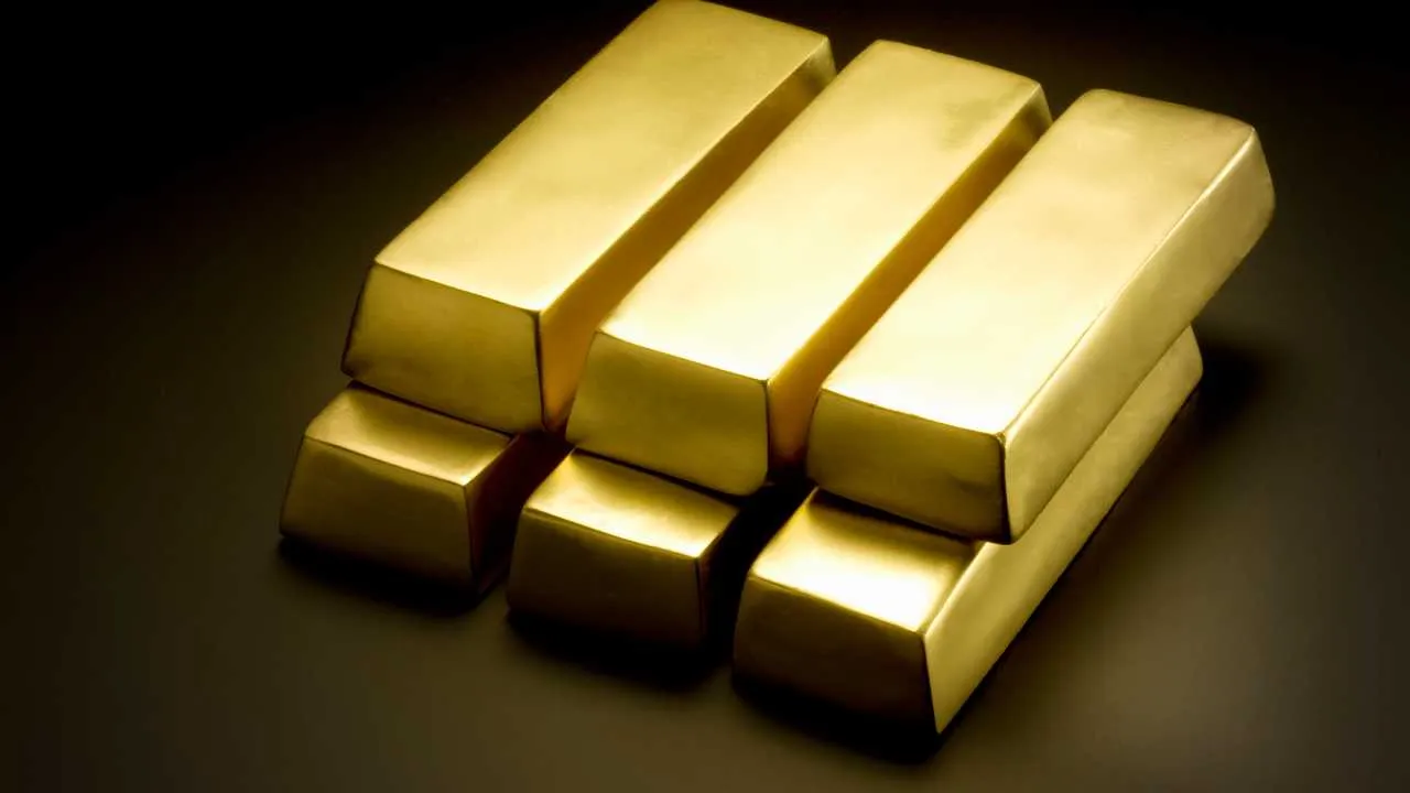 Stacked gold bars on a dark background