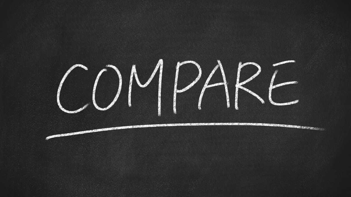 The word COMPARE is written in white chalk on a blackboard