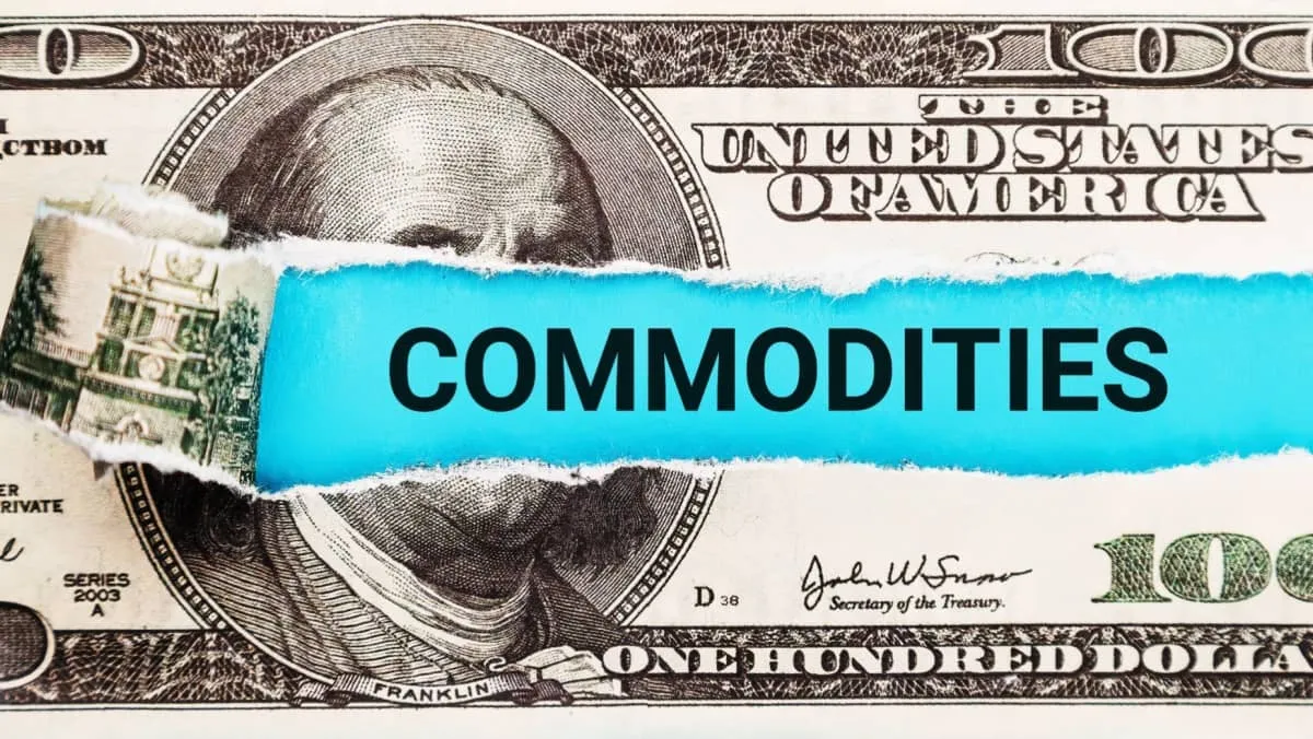 The word Commodities in the background of the US dollar