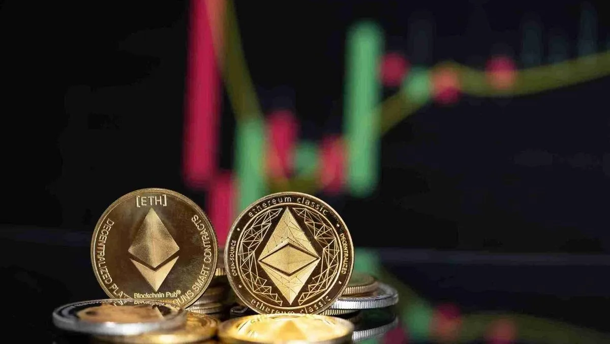 Two Ethereum coins and a blurry candlestick pattern in the background