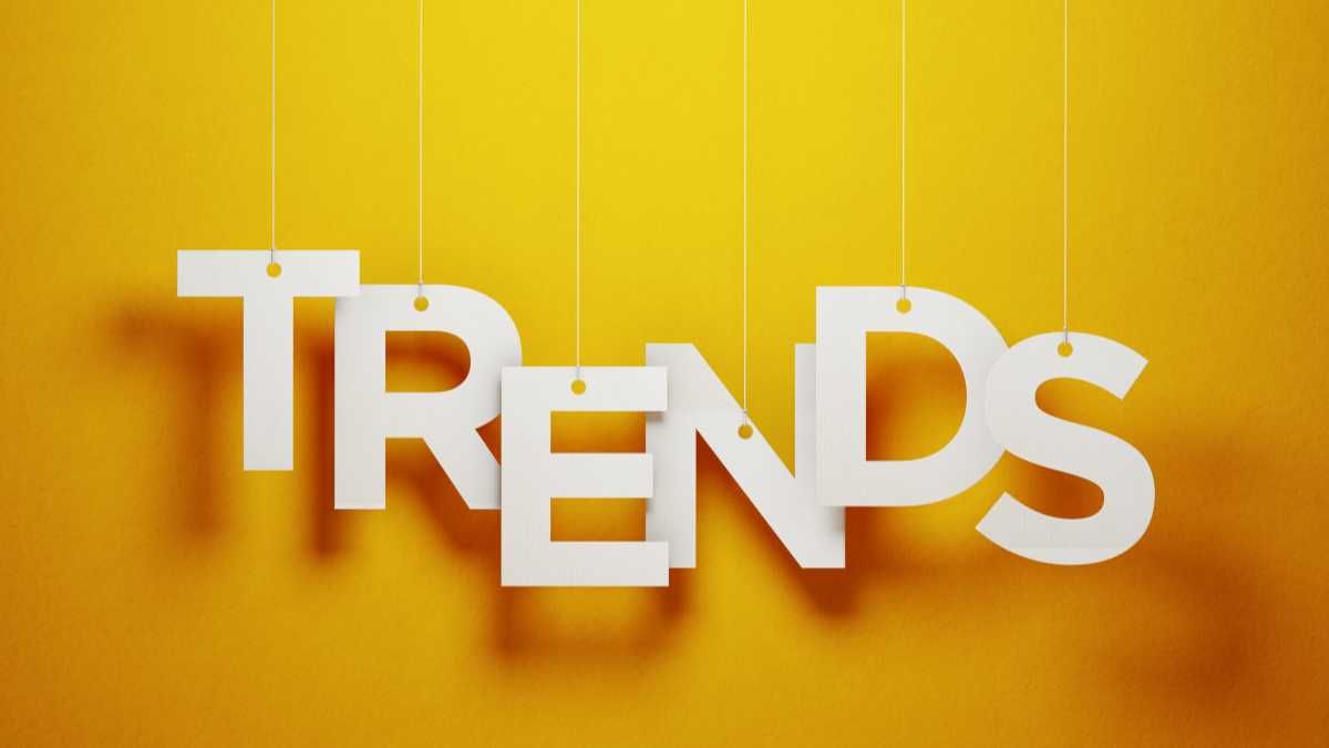 White letters spelling  TRENDS  hanging against a yellow background