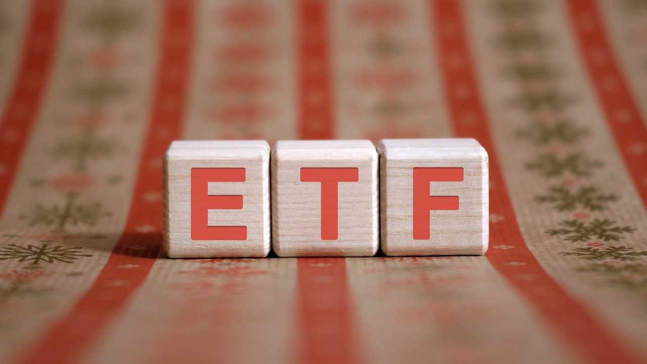 Wooden blocks with ETF letters on a patterned tablecloth